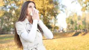 young woman have flu, autumn park